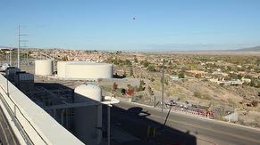 Rooftop view from central utility building of two 1-million gallon water tanks, 250,000 gallon fire system water tank, oil-free air tank, emergency generator exhaust stack, the Village of Corrales and North Valley.